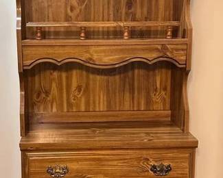 A classic mid-century inspired storage piece featuring a rich faux-wood grain laminate finish. This versatile unit works well in a bedroom, home office, or even a craft room. Main Chest: Features five spacious drawers with integrated pull handles for a clean, streamlined look. Detachable Top Unit: Includes a matching two-shelf hutch that sits securely on top, perfect for displaying books, photos, or décor. It can be removed to use the chest as a standard flat-top dresser. Construction: Durable laminate over wood composite, making it easy to clean and resistant to surface scratches. Condition: Good vintage condition. Shows minor age-appropriate wear to the edges and laminate, but the drawers operate smoothly and the unit is structurally sound. Smoke free pet free