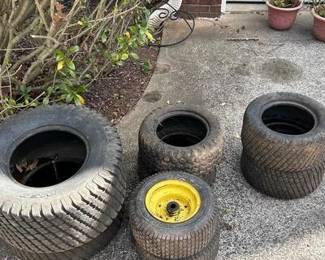 A complete replacement or project lot for riding mowers and lawn tractors. This bundle includes a total of six tires/wheels: • 2 Large Rear Tires: Size 20 x 8.00 - 8 Multi-Trac C/S turf tires. • 2 Mid-Size Tires: Size 15 x 6.00 - 6 turf tires. • 2 Smaller Front Wheels: Integrated rim and tire assemblies for front-end mower support. • Condition: Tires show plenty of remaining tread. Ideal for a mechanic's stockpile or replacing worn tread on an existing L-series John Deere or similar tractor.
