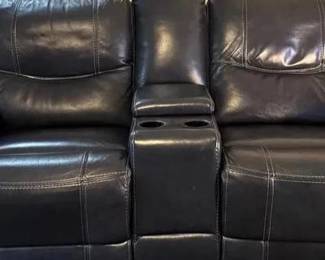 Power Recliner Sofa And Chair(2 Items) Navy leather like power recliner sofa and chair. Center console in sofa with electric plugs. Individual position controls on each end. Sofa is 84w/39d/35h