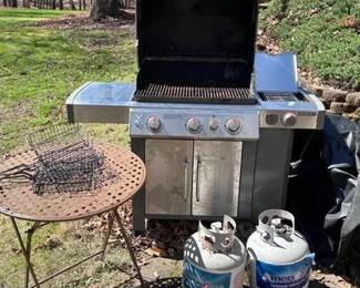 Get ready for grilling season with this complete outdoor entertaining lot. This set includes high-capacity cooking equipment and comfort seating: • Nexgrill 5-Burner Propane Grill: A large stainless steel and black gas grill featuring five main burners and a dedicated side burner. Includes an integrated temperature gauge and lower cabinet storage for a propane tank. • Outdoor Propane Deep Fryer/Boiler: A sturdy black metal burner stand equipped with a large aluminum pot and strainer basket. Perfect for turkey fries, low-country boils, or fish fries. Includes regulator and hose. • Adirondack-Style Patio Chairs: Two (2) matching high-back outdoor lounge chairs in a versatile tan/neutral finish. Designed with wide armrests and a comfortable reclined profile. • Accessories: Includes a weather-resistant grill cover to protect the Nexgrill when not in use. Condition: The Nexgrill shows signs of previous use but has been kept under a cover. The fryer and chairs are in good, sturdy condition.