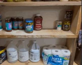 A massive high-value lot perfect for stocking a pantry, shelter, or donation center. This comprehensive collection includes a wide variety of long-shelf-life goods and kitchen essentials: Canned Goods & Staples: Large quantities of canned vegetables (corn, green beans), soups (Campbell’s), tomato sauce, pasta, and boxed cereal (Raisin Bran). Condiments & Jars: Assorted BBQ sauces (Sweet Baby Ray's), pickles, peanut butter, pancake syrup, and various jarred salsas/sauces. Paper & Cleaning Supplies: Multi-packs of "Soft & Strong" bath tissue and large containers of cleaning/maintenance liquids. Kitchen Hardware: Includes a heavy-duty stainless steel stock pot, a large aluminum commercial-style baking/utility tray, and a black insulated tool or gear bag. Condition: All food items are factory-sealed. Bidders are encouraged to verify expiration dates upon pickup. Kitchenware is in good, used condition.