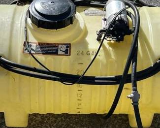 A genuine John Deere 25-gallon tow-behind sprayer, perfect for maintaining large lawns, pastures, or food plots. This unit is designed to be pulled by a riding mower or ATV. • Key Features: Includes the integrated 12V pump, handheld spray wand for spot treating, and a large 25-gallon capacity poly tank with gallon/liter graduation marks for easy mixing. • Condition: The unit is in good cosmetic condition. The previous owner has noted that it "Works Good" (handwritten on the tank cap). • Compatibility: Features a standard hitch pin plate for easy attachment to most lawn tractors.