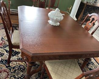 Vintage solid wood dining table; three leaves; 6 chairs (one needs repair); one captain's chair; matches hutch and console cabinet