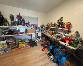 Wide view of the pop culture room packed with Star Wars, Spider-Man, Superman, Batman, PEZ, robots, vintage toys, character collectibles, games, and sci-fi memorabilia. Loaded shelves and floor displays with nostalgic collector pieces and reseller-friendly finds throughout.