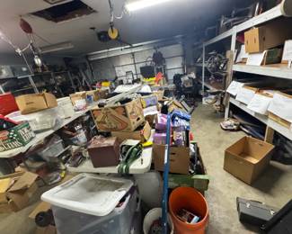 Garage and workshop picker area packed with overflow inventory, sorted shelves, boxes of collectibles, tools, thermoses, lunch boxes, household vintage, and resale lots. True digger’s setup with plenty more to uncover for pickers, resellers, and bargain hunters.