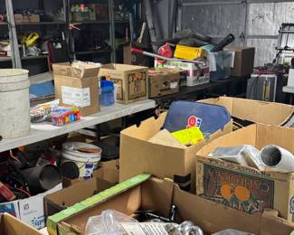Garage picker area packed with boxes of hardware, automotive parts, shop supplies, tools, and mixed garage overflow inventory. Great dig-through setup for resellers, mechanics, and bargain hunters looking for useful parts, project pieces, and hidden finds.