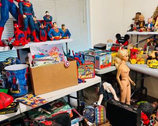 Collector room featuring Superman, Spider-Man, Star Wars, vintage lunch boxes, robots, character toys, pop culture memorabilia, and retro novelty pieces. Strong mix of superhero collectibles, lunch box collection, and nostalgic display items for toy collectors and resellers.