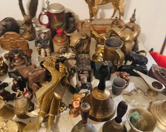 Antique and vintage brass table featuring horse and eagle figures, bells, animal statues, primitive tools, metalware, steins, and rustic collectible smalls. Great mix of Western, Americana, and one-of-a-kind decor pieces for antique buyers, collectors, and resellers.