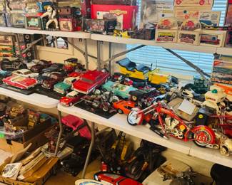 Large transportation and model collectible display packed with die-cast classic cars, motorcycles, trains, trucks, boxed model kits, and loose automotive memorabilia. Great variety of vintage and modern vehicle collectibles for hobbyists, display collectors, and resellers.
