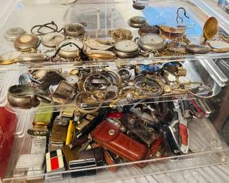 Display case loaded with vintage pocket watches, wristwatches, pocket knives, lighters, cigarette cases, and small collectible accessories. Great assortment of men’s vintage collectibles, everyday carry items, and reseller-friendly smalls.