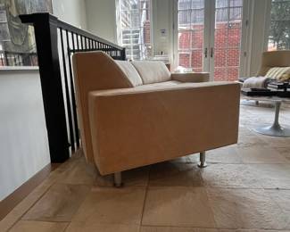 curved sofa has metal legs