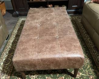 Button tufted leather ottoman