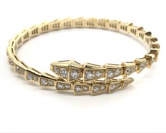 This elegant Bulgari Serpenti Viper bangle bracelet is crafted in solid 18K gold and features the iconic serpent motif, set throughout with brilliant pavé-set diamonds that create exceptional brilliance and refined luxury. The sleek, sculptural silhouette reflects Bulgari’s distinctive design language, combining fluid form with bold visual presence. Featuring the highly sought-after Viper configuration, this bracelet represents a more collectible and desirable example from Bulgari’s renowned Serpenti collection.
