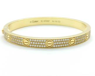 This iconic Cartier Love Collection bangle bracelet is crafted in solid 18K gold and features a full pavé diamond design that creates exceptional brilliance and timeless elegance. The signature Love bracelet motif, defined by its clean lines and symbolic design, represents enduring commitment and remains one of Cartier’s most recognizable creations. Featuring the highly sought-after full diamond pavé configuration, this bracelet represents a more collectible and desirable example from Cartier’s renowned Love collection.