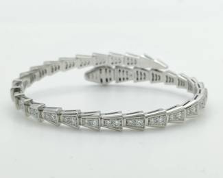 This refined Bulgari Serpenti Viper bangle bracelet is crafted in solid 18K gold and features the iconic serpent motif, set with brilliant pavé-set diamonds that create exceptional brilliance and elegance. The sleek, sculptural design wraps fluidly around the wrist, reflecting Bulgari’s distinctive aesthetic and mastery of form. Featuring the highly sought-after Viper configuration and full diamond pavé design, this bracelet represents a more collectible and desirable example from Bulgari’s renowned Serpenti collection.