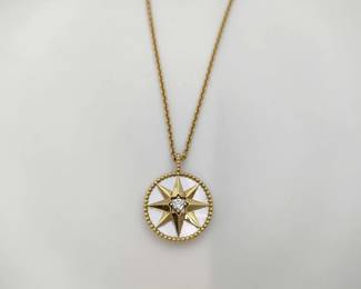 Elegant Dior Rose des Vents large model necklace crafted in 18K yellow gold featuring the Maison’s iconic compass rose medallion. The design is set with luminous mother of pearl and accented with a central diamond, creating a refined celestial aesthetic. This larger medallion version paired with a longer chain offers a striking and elegant interpretation of the Rose des Vents collection inspired by Christian Dior’s fascination with lucky stars.
