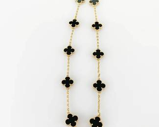 This exquisite Van Cleef & Arpels Vintage Alhambra necklace features ten elegant motifs made of polished Black Onyx set in luxurious 18K yellow gold. Each clover-shaped pendant exhibits intricate detailing around the edges, exemplifying the Maison's renowned craftsmanship and timeless design. Crafted in France between 2010 and 2019, this striking necklace comes in very good pre-owned condition and includes its original presentation box, making it a remarkable addition to any fine jewelry collection.