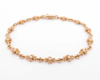 Distinctive Chrome Hearts Tiny E bracelet crafted in solid gold, featuring the brand’s signature repeating cross motifs set with diamonds and connected by fine interlocking links. The elegant proportions and iconic gothic-inspired design reflect Chrome Hearts’ renowned craftsmanship and attention to detail. A rare and highly collectible Chrome Hearts bracelet suitable for everyday wear or layering.