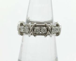 Elegant Tiffany & Co. ring designed by Jean Schlumberger, crafted in platinum and set with brilliant-cut diamonds. The design features Schlumberger’s signature cross-bar motif separating rows of diamonds, creating a distinctive and sculptural composition. Refined yet bold, the ring showcases the exceptional craftsmanship and timeless design associated with Tiffany’s legendary designer collections.