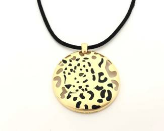 This distinctive Cartier Panthère pendant necklace is crafted in solid 18K gold and features the iconic black spotted leopard motif, showcasing Cartier’s legendary animal design with bold contrast and refined detail. The pendant is suspended from an elegant black rope necklace, creating a striking combination of texture and luxury. Featuring a unique and sought-after Panthère configuration, this necklace represents a more collectible and desirable example from Cartier’s renowned Panthère collection.