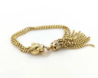 This exceptional Cartier Panthère bracelet is crafted in solid 18K gold and features the iconic leopard motif, accented with brilliant pavé-set diamonds that create striking brilliance and refined detail. The design is enhanced by a distinctive diamond bead tassel element, adding fluid movement and elevating its sculptural elegance. Featuring a rare and unique tassel configuration, this bracelet represents a highly collectible and desirable example from Cartier’s renowned Panthère collection.