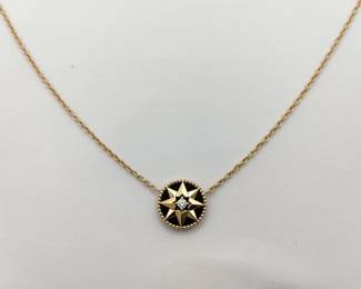 Elegant Dior Rose des Vents necklace crafted in 18K yellow gold featuring the Maison’s iconic compass rose motif. The medallion design is set against deep black onyx and accented with a central diamond, creating a striking contrast and refined celestial aesthetic. Inspired by Christian Dior’s fascination with lucky symbols and navigation, this piece embodies the elegance of the Rose des Vents collection.