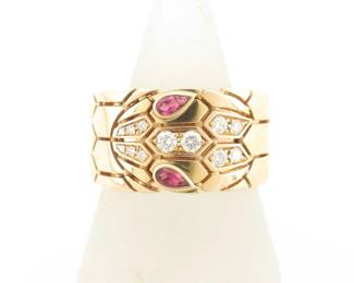 This striking Bulgari Serpenti Viper wide band ring is crafted in solid 18K gold and features the iconic snake motif, accented with vivid pink tourmaline gemstones forming the serpent’s eyes. The bold, sculptural wide band design creates a powerful and elegant presence, reflecting Bulgari’s distinctive and highly recognizable aesthetic. Featuring the sought-after Viper configuration and unique gemstone detail, this ring represents a more collectible and desirable example from Bulgari’s renowned Serpenti collection.