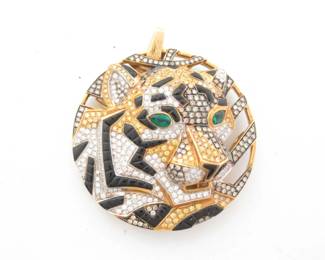 This exceptional Cartier Panthère medallion pendant is crafted in solid 18K gold and features a striking tiger interpretation of the iconic panther motif, accented with brilliant fancy color pavé-set diamonds and contrasting black onyx. The intricate design highlights remarkable detail and dimensional artistry, capturing the strength and elegance associated with Cartier’s legendary animal creations. Featuring a rare and unique configuration with distinctive gemstone combination, this pendant represents a highly collectible and desirable example from Cartier’s renowned Panthère collection.