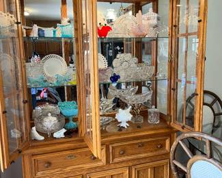 Lighted China cabinet filled with collectible glassware
