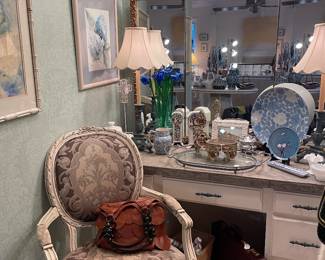 View of master bedroom vanity with French armchair