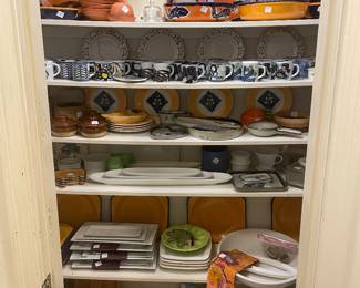Kitchen hall pantry of Mexican pottery , studio art pottery and Royal Copenhagen mugs and other serving dishes