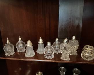 Nice selection of salt and pepper shakers with sterling silver lids