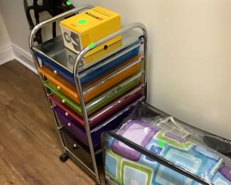 Metal stand with several colored drawers.