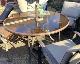 Glass top round patio table with chairs.