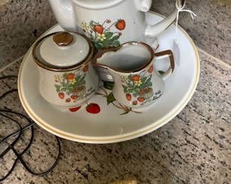 Cutest strawberry coffee pot with matching creamer and sugar dish.