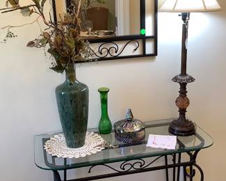 Metal and glass table in foyer and mirror to match.