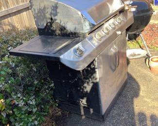 Gas grill.  Has utensils and gas bottle.