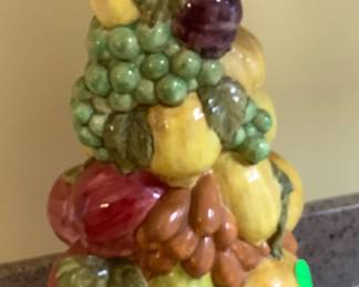 Ceramic fruit tree sitting on base.
