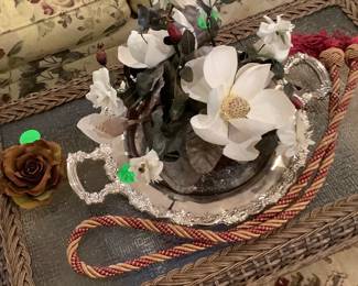 Flower arrangement on wicker coffee table with glass.  Sitting on beautiful silver tray.