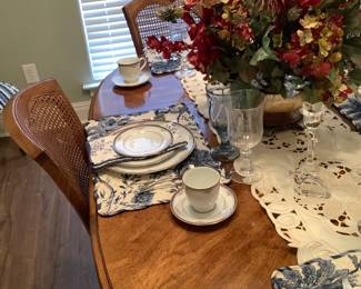 This walnut table has 8 chairs with cane back chairs, 2 of the chairs are arm chairs.  It measures 66” long, 42” wide,, 29” tall.  Has a leaf that measures 17” wide.  Price: $325.00