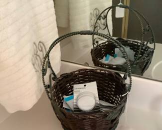 Metal and wicker basket with facial items.