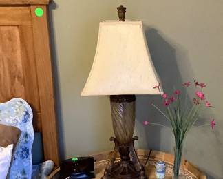 Beautiful round tray carved sitting on metal stand.