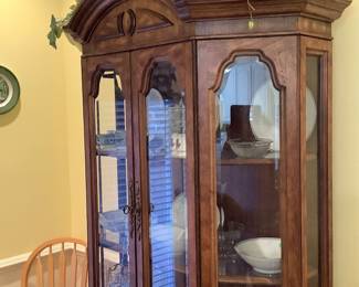 Rounded China cabinet.  Has light. Measures 82” tall, 9” depth, 52” wide, Price: $135.00 Has glass shelves.