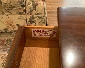 Inside drawer of the two matching end tables describing type of wood.  Both have bottom shelves and drawer.