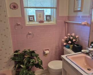 Now for my favorite room in the whole house...and not because is a bathroom!  It's PINK!!!  It's original!!! It's awesome!!!  The plant on the floor is actually covering the hole for the laundry chute my Mom and Grandpa made! 