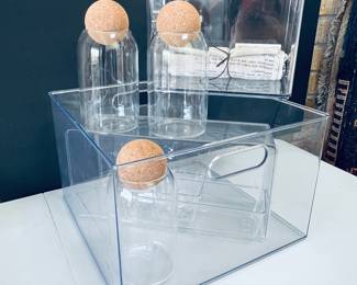 Clear Acrylic Storage Box with Set of Three Glass Bottles Featuring Cork Stoppers and Decorative Sugar Cookies Towel