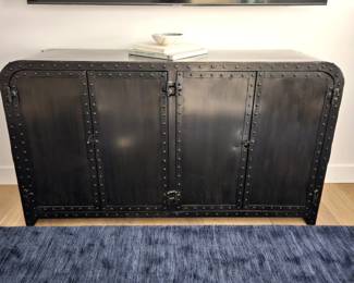 Industrial-style metal sideboard cabinet featuring a black iron finish with riveted detailing and rounded corners