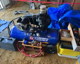 This is a Campbell Hausfeld air compressor.  Very useful for blowing dust off of workpieces, or inflating soccer balls, or...