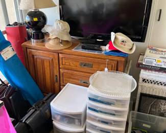 Another dresser or cabinet supports this television.  Come take a look inside the smaller drawers in front.