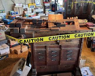 This picture shows a vintage workbench with a front vice and tail vice, along with some very large parallel jaw clamps.